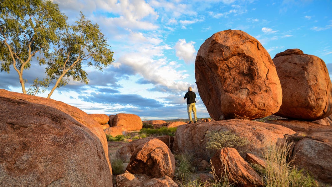 Man standing at Karlu Karlu Devils Marbles near Tennant Creek