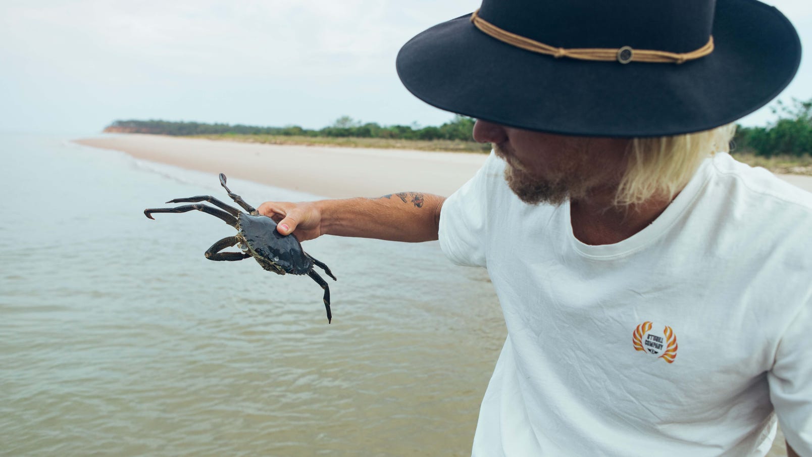 Man holding a crab on the Tiwi Islands Clearwater Island Lodge Marine Culture Tour
