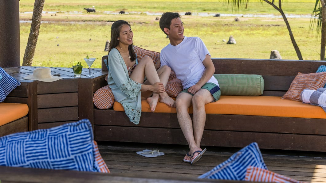 Couple-enjoying-a-drink-at-Bamurru-Plains-pool-deck