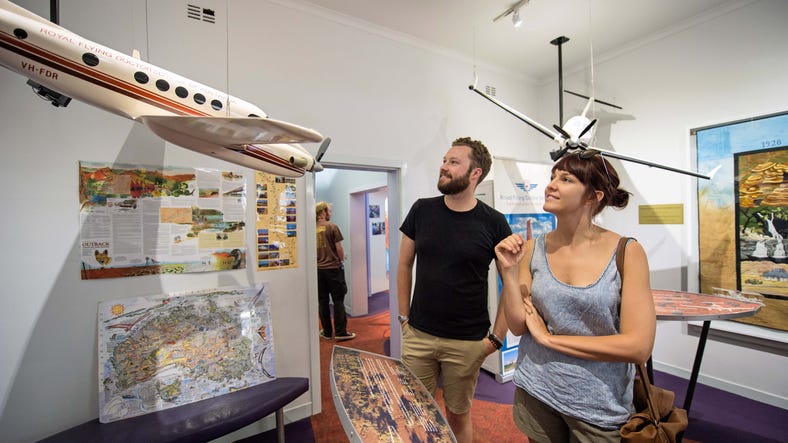 People looking at an exhibit at the Royal Flying Doctor Service