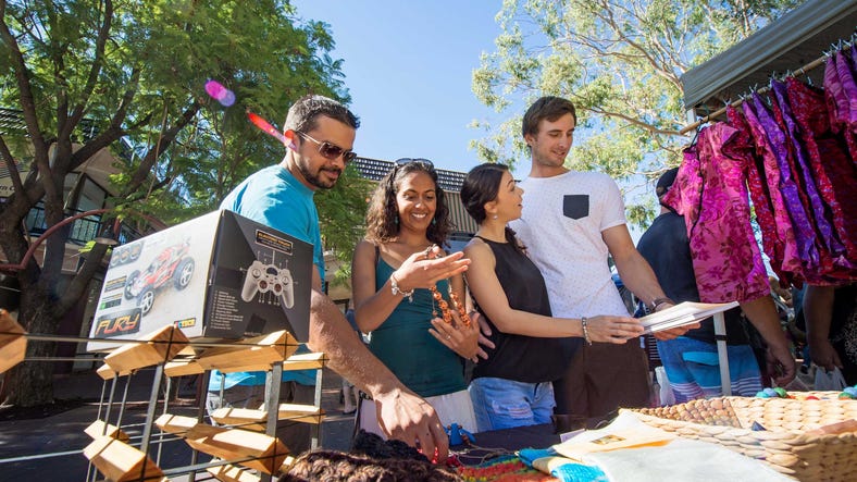 group viewing items to purchase at the todd mall markets