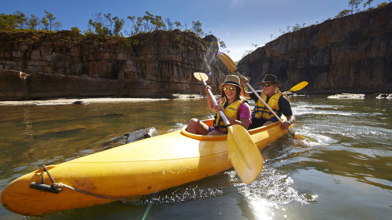 Two people canoeing through Nitmiluk Gorge